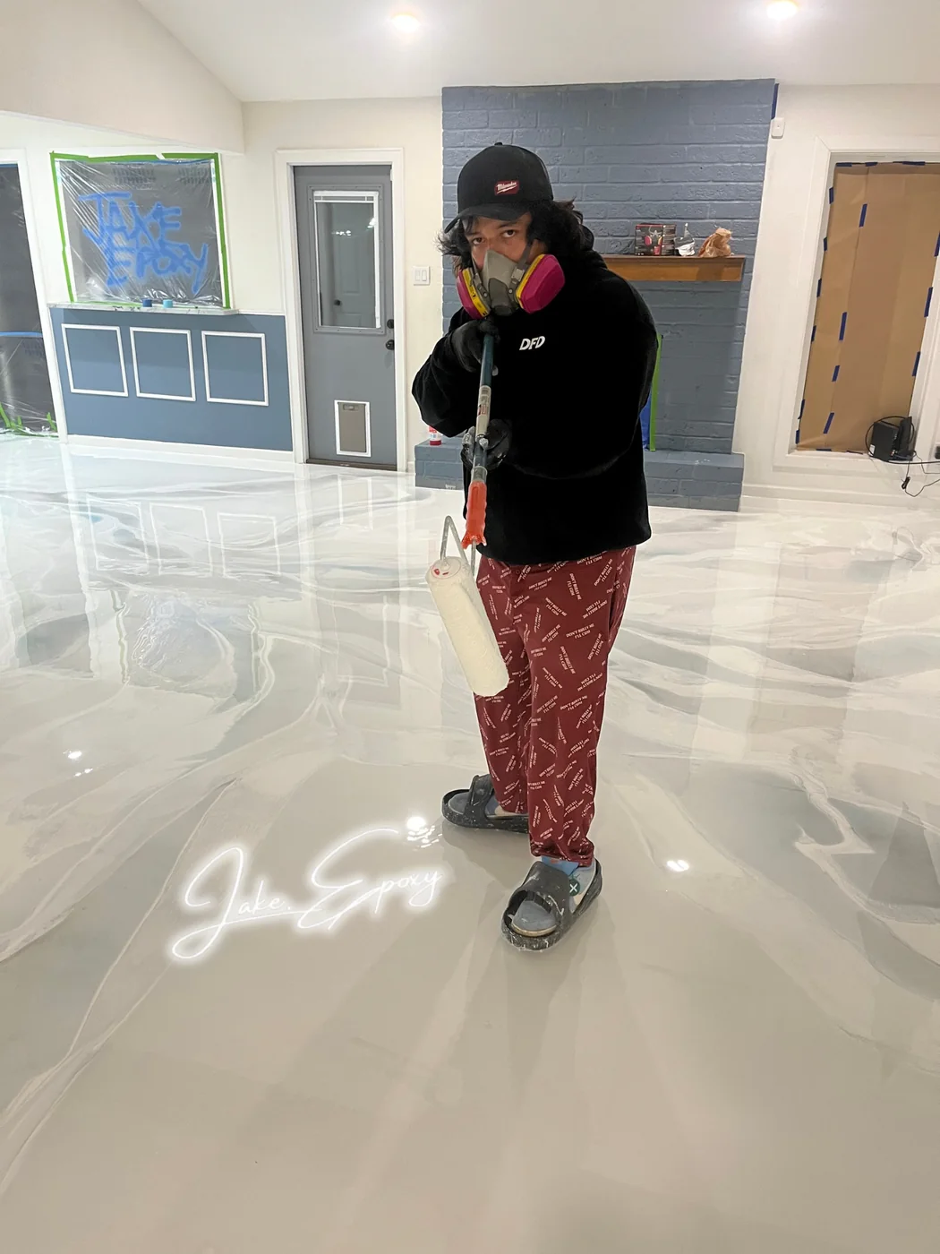 Installer standing on white metallic epoxy floor